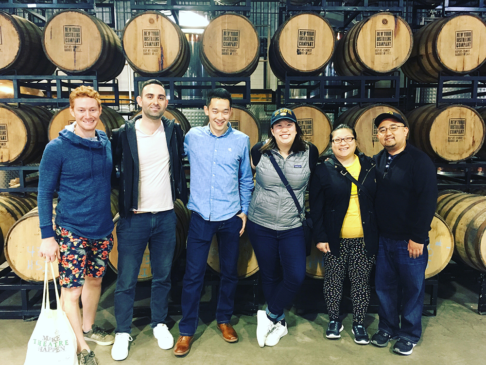 New York UC Davis alumni posing in a distillery