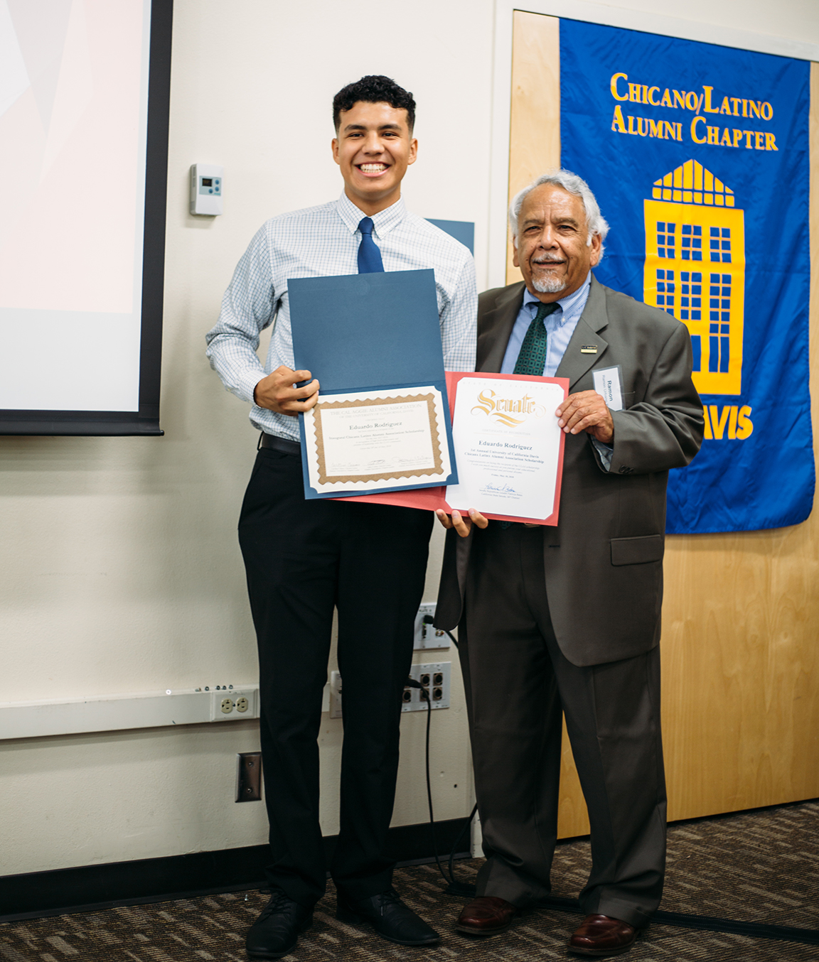 Student receiving a scholarship from the Chicanx Latinx Alumni Association