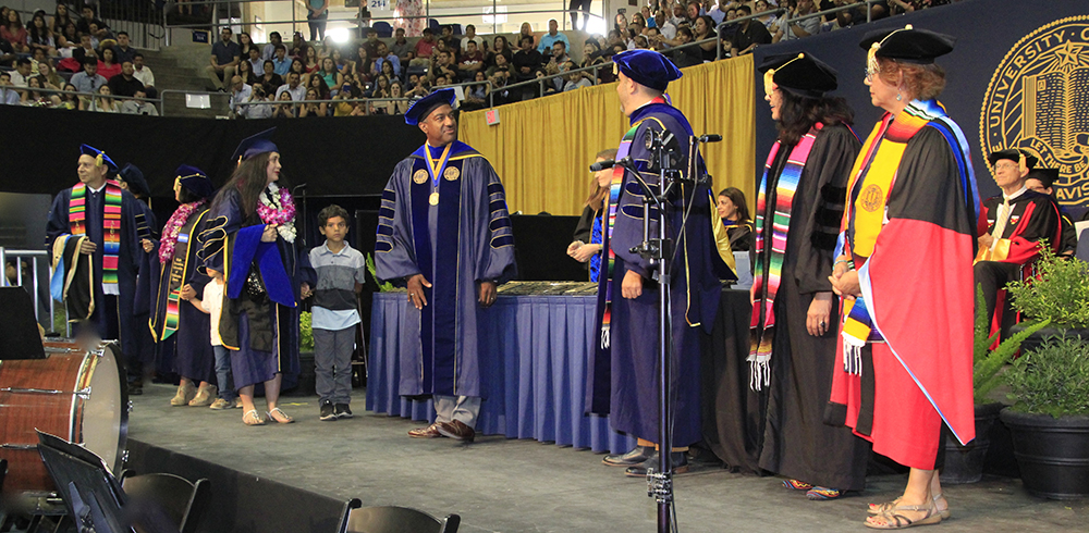 Gary May with students at graduation