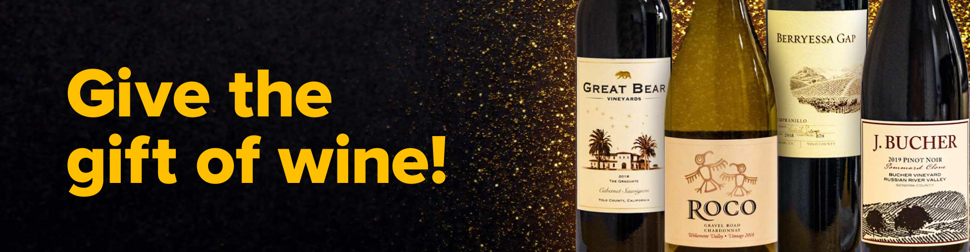 Give the gift of wine! Photo of four wine bottles with sparkly gold background.