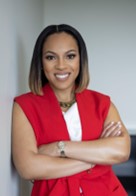 Headshot of Shayla Smith with arms folded wearing a red dress.