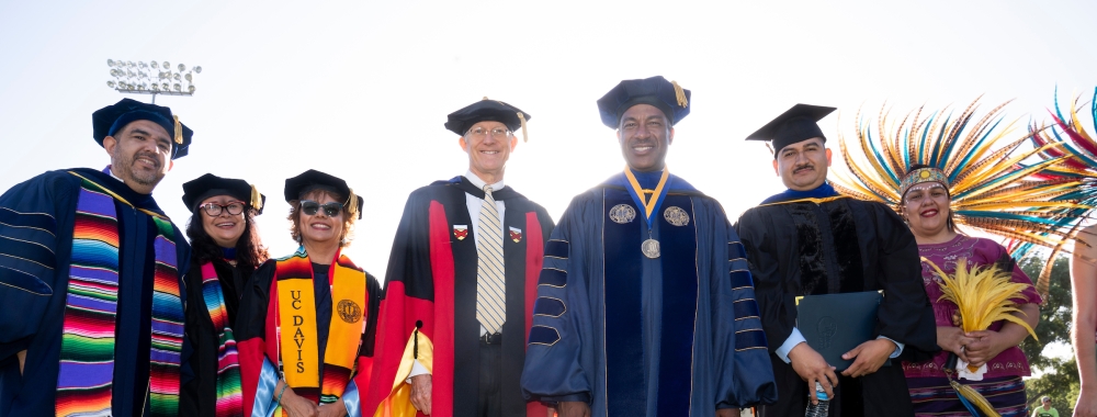 Chancellor Gary May poses with faculty members before the start of the Chicanx/Latinx Graduation Celebration at the Pavilion.