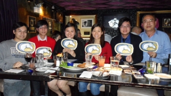 Six people sitting behind a table 