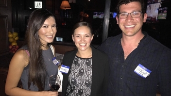 Two women and a man smiling 