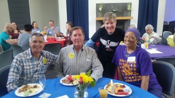 Four people sitting at a table 