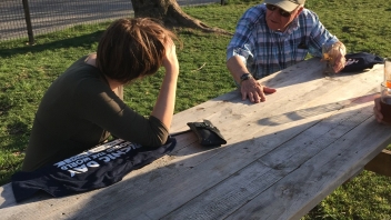 Young man talking to older man 