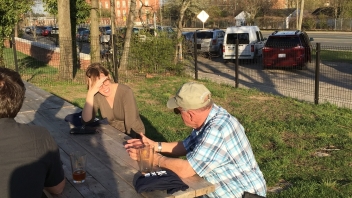 People talking at picnic tables 