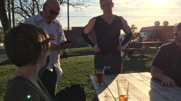 People talking at picnic tables 