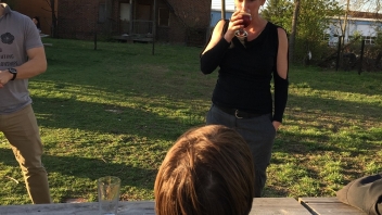 Women drinking glass of wine at picnic table 