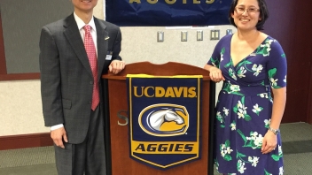 Two people standing next to podium 