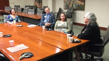 People sitting at conference desk 