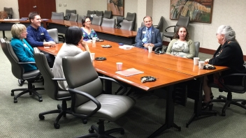 People sitting at conference desk 