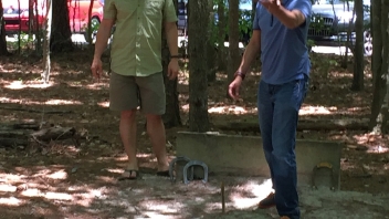 Two men playing bean bag toss 