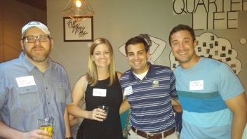 Four Aggies smiling