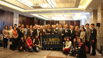 Group of Aggies holding up UC Davis flag 