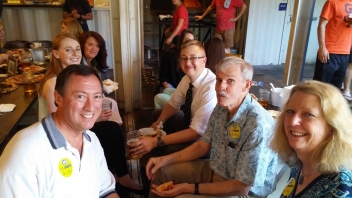 A few people sitting near a table 