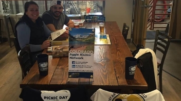 Alumnus and Alumi sitting at a table 