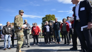 Army man talking to crowd 