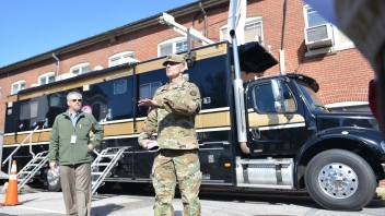 Army man in front of truck 