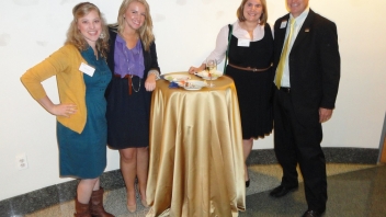 People standing around a round table 