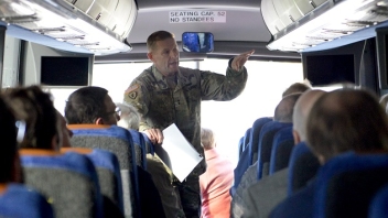 Man talking to people on a bus 