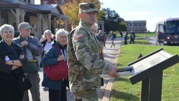 Army man talking to crowd 