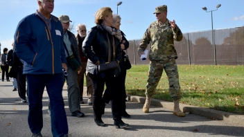 Army man walking with crowd 