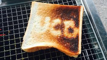 Toast on a grill with letters UCD on it 
