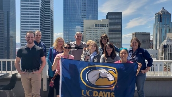 Group of alumni with Seattle skyline in the background