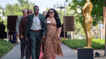 Olivia M. Campa, M.D. ’14 walking down the red carpet with her partner.