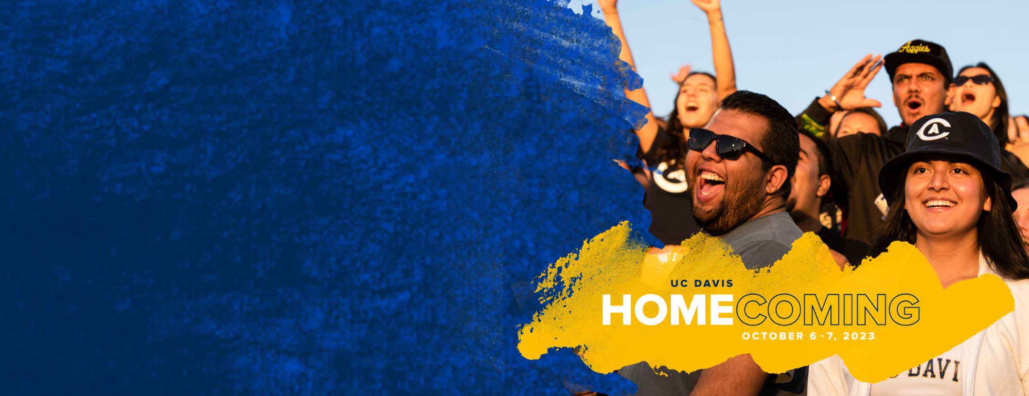 UC Davis Homecoming on October 6-7, 2023. Photo of two people cheering at a football game.