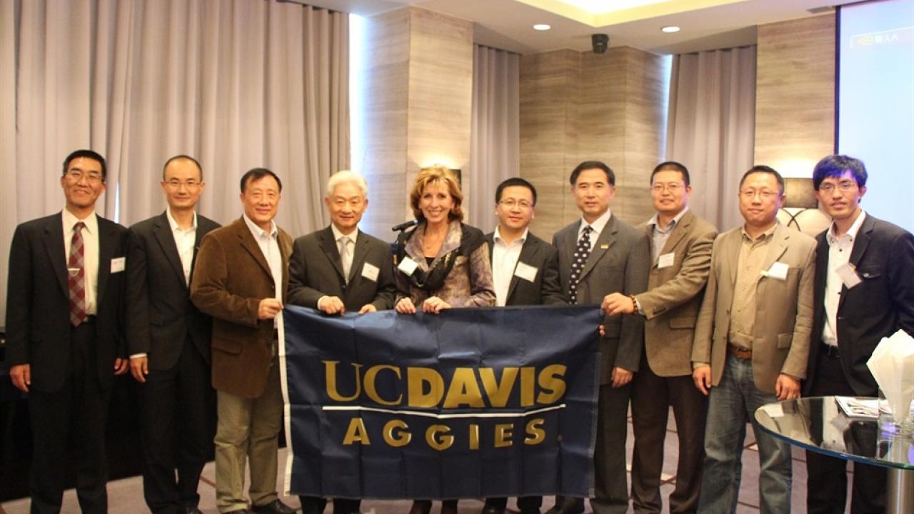 Aggies holding up UC Davis flag 
