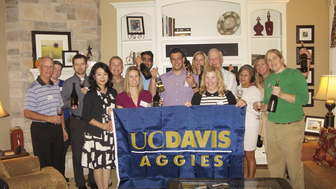 Houston Aggies holding up a UC Davis flag 