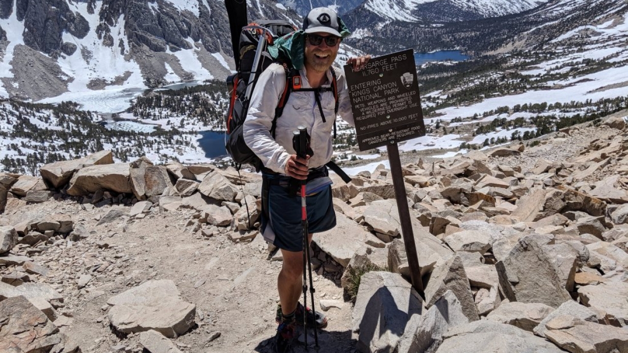 Soren standing at a mile marker