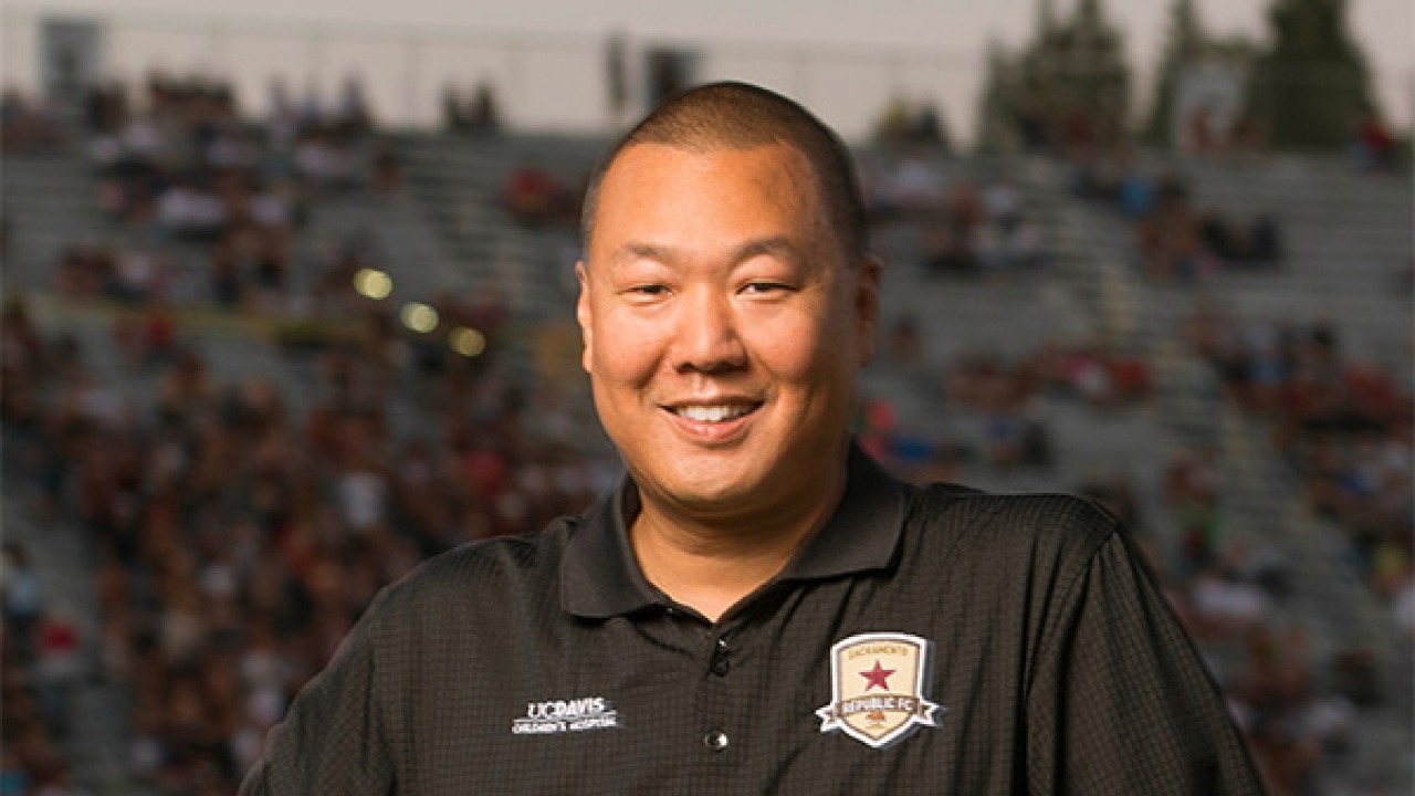 Brent Sasaki, who majored in political science at UC Davis and now works at the Sacramento Republic FC, has hired hardworking Aggies that he met through CAAA’s strong alumni network. Brent Sasaki holding soccer ball