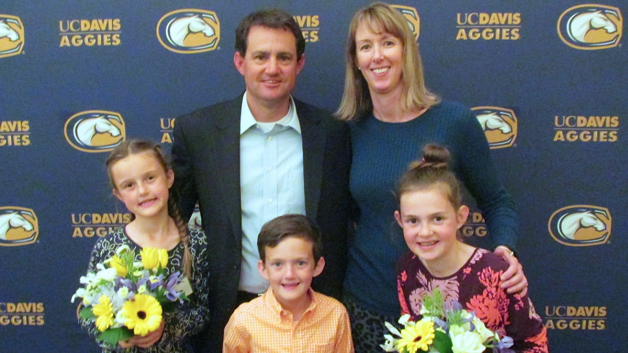 David Nix played outfield for the 1995 UC Davis baseball team that advanced to the College World Series. Last year, he and his wife Sarah brought their children to enjoy the team’s 20-year reunion celebration of that stellar year. David Nix posing with his family in front of a UC Davis Aggies backdrop