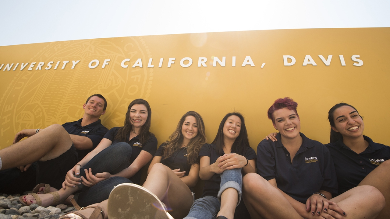 Students in front of a UC Davis sign