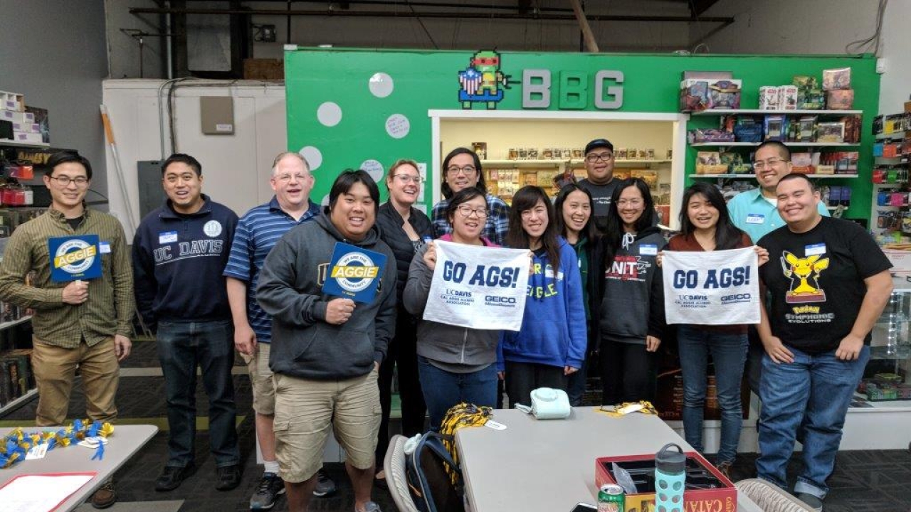 Group of alumni and friends at a board game night in 2018