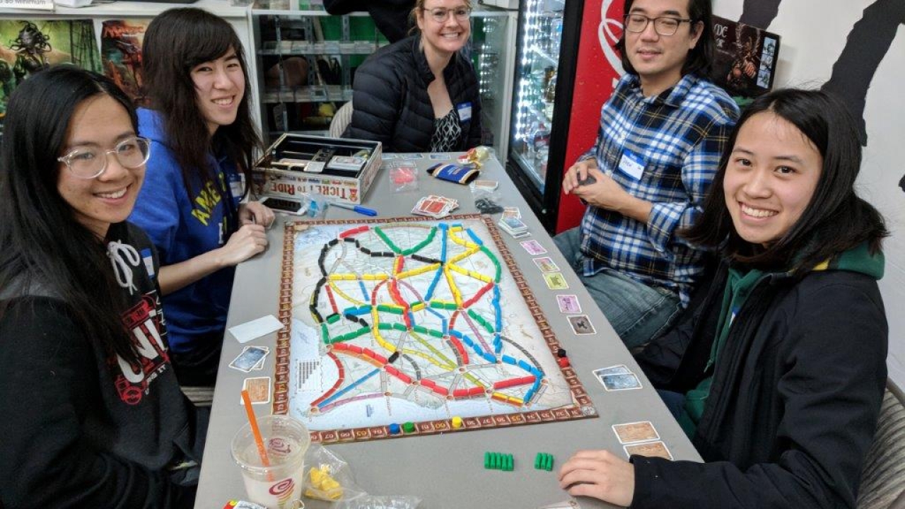 Group of alumni and friends at a game night