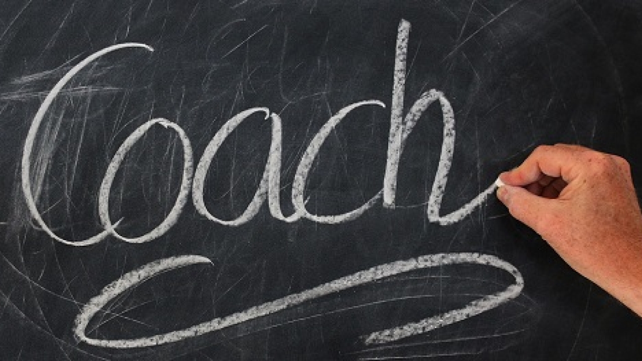 Hand writing coach in chalk on a chalkboard