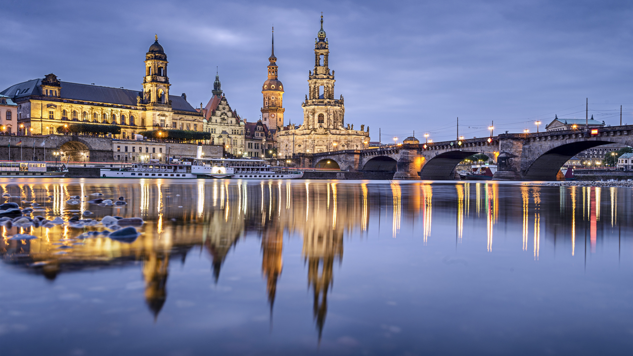 Night view of Dresden, Germany with reflective water.