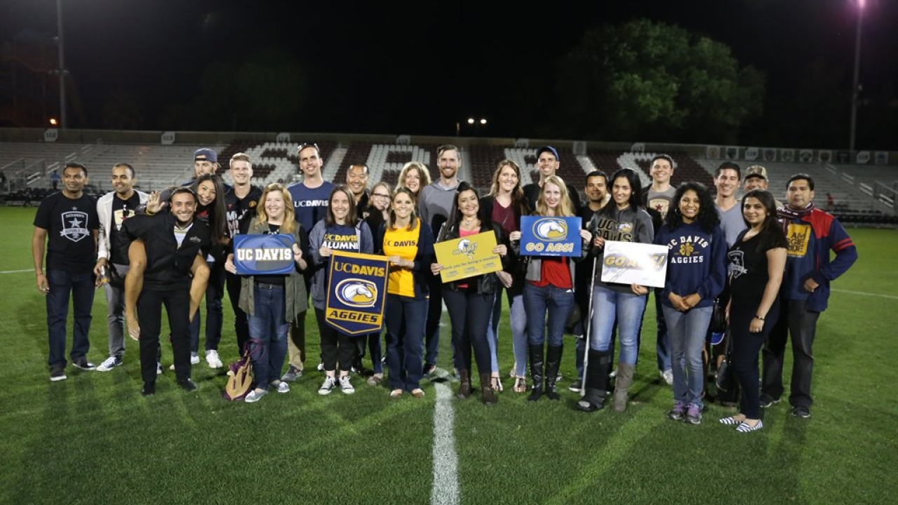 Group of Aggies on football field. 