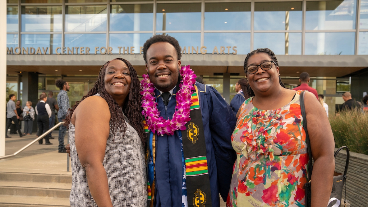 family at graduation smiling