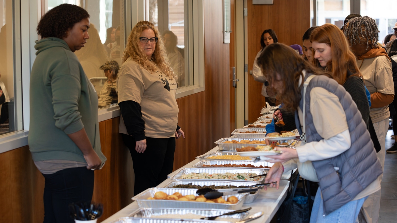 People waiting in line for food inside King Hall outside the lecture hall.