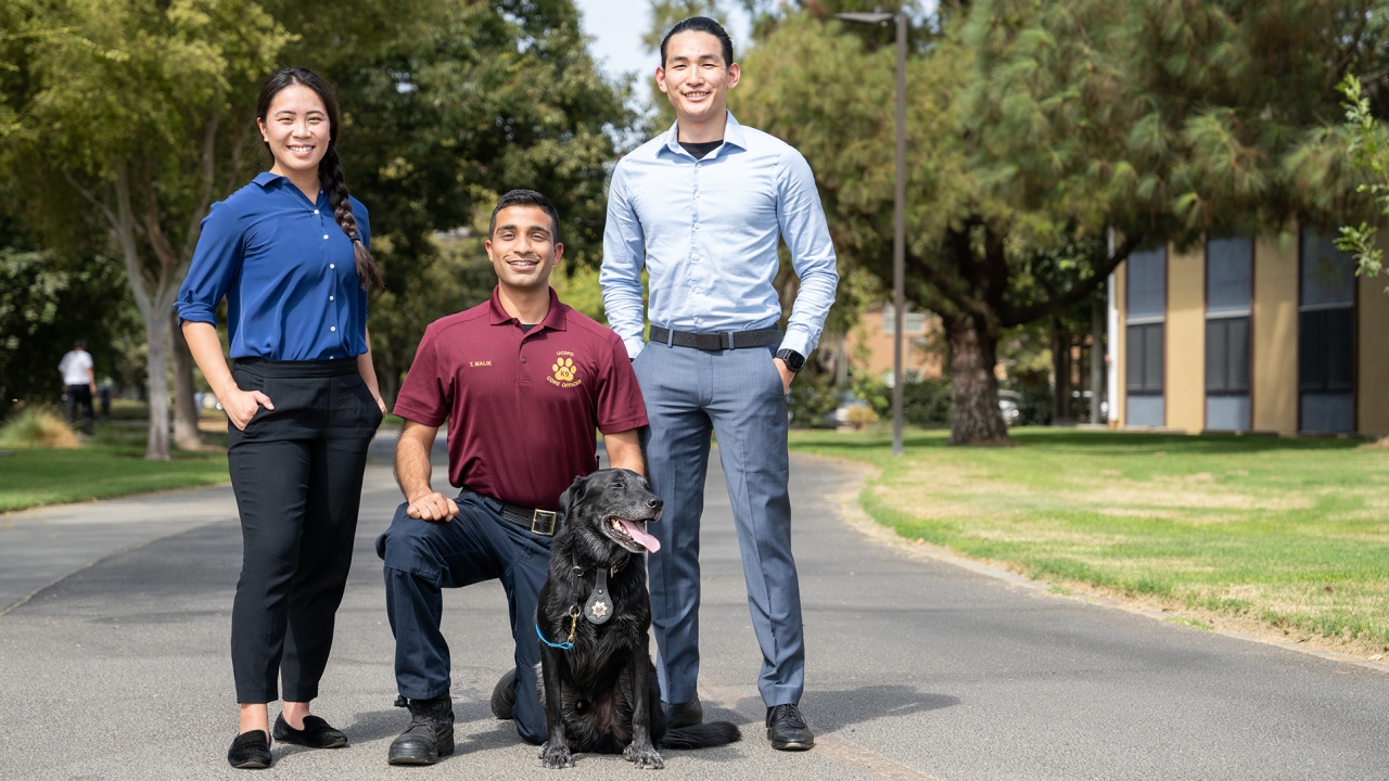 From left to right: CORE Officers Jena Du ’15, Tabbasum Malik ’19 with K-9 Charlie, and Ricky Lee ’16.