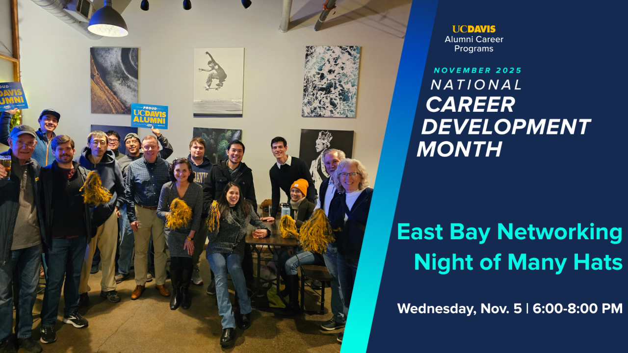 Group of people holding signs saying, "Go Ags" and "Proud UC Davis Alumni" and a banner saying "Cal Aggie Alumni Association"