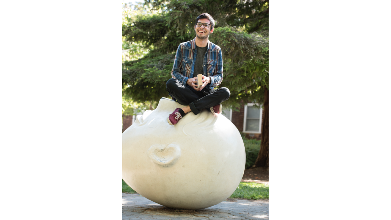 Man sitting on an egghead on the UC Davis campus