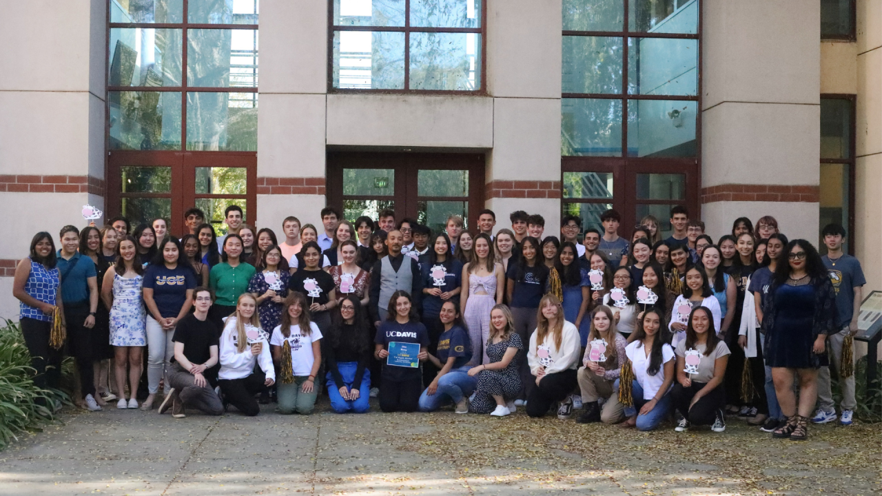 group of leadership scholarship students standing in front of the alumni center