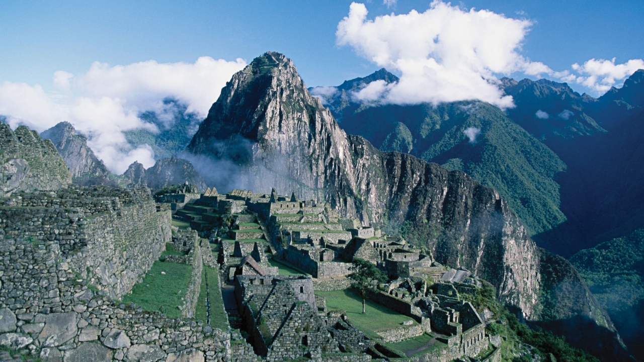 An aerial view of the Machu Picchu ruins in the lush mountains of Peru.