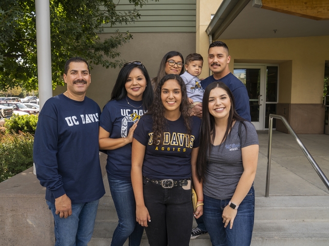 Family standing outside a residence hall at UC Davis